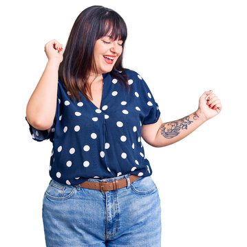 Young plus size woman wearing casual clothes dancing happy and cheerful, smiling moving casual and confident listening to music