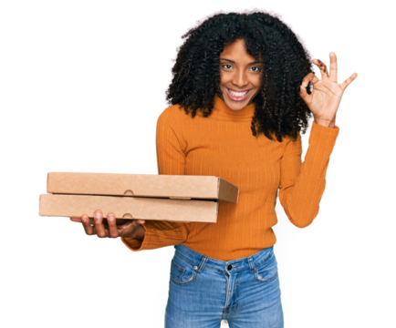 Young african american girl holding delivery pizza box doing ok sign with fingers, smiling friendly gesturing excellent symbol