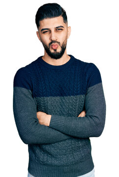 Young arab man with beard with arms crossed gesture looking at the camera blowing a kiss being lovely and sexy. love expression.