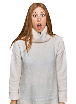 Young irish woman wearing casual winter sweater afraid and shocked with surprise and amazed expression, fear and excited face.