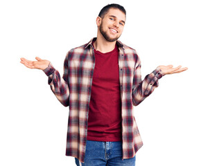 Young handsome man wearing casual shirt smiling showing both hands open palms, presenting and advertising comparison and balance