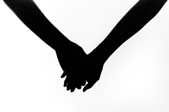 Silhouette of a couple holding hands