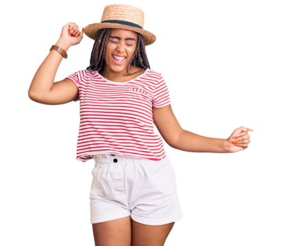 Young african american woman with braids wearing summer hat dancing happy and cheerful, smiling moving casual and confident listening to music