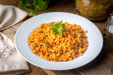 Traditional turkish bulgur pilaf with tomato sause in plate (Turkish name; meyhane pilavi)