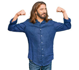 Attractive man with long hair and beard wearing casual clothes showing arms muscles smiling proud. fitness concept.