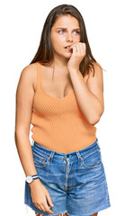 Young caucasian woman wearing casual clothes looking stressed and nervous with hands on mouth biting nails. anxiety problem.