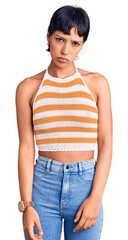 Fototapeta premium Young brunette woman with short hair wearing casual clothes depressed and worry for distress, crying angry and afraid. sad expression.