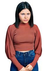 Young brunette woman with blue eyes wearing elegant sweater skeptic and nervous, frowning upset because of problem. negative person.