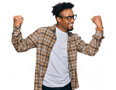Young african american man with beard wearing casual clothes and glasses very happy and excited doing winner gesture with arms raised, smiling and screaming for success. celebration concept. - Powered by Adobe