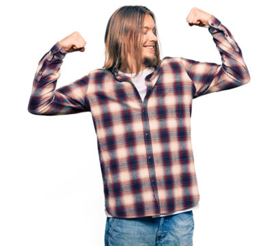 Handsome caucasian man with long hair wearing hipster shirt showing arms muscles smiling proud. fitness concept.