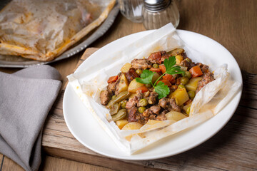 Traditional Turkish food; Meat with vegetables wrapped in greaseproof paper, kebab (Turkish name; Sebzeli kagit kebabi)
