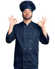 Young hispanic man wearing cooker uniform relax and smiling with eyes closed doing meditation gesture with fingers. yoga concept.
