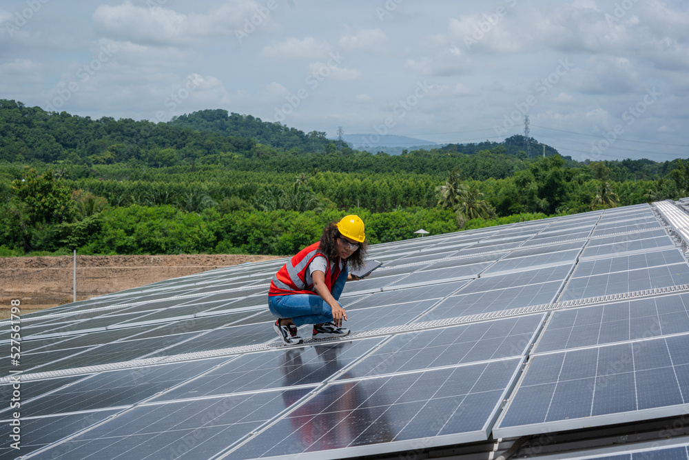 Poster solar power,engineer inspect solar panels on the roof of a factory where solar panels are installed 
