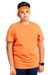 Little boy kid wearing sportswear looking sleepy and tired, exhausted for fatigue and hangover, lazy eyes in the morning.