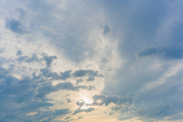 Naklejka na ściany i meble Evening cloudy sky with the setting sun