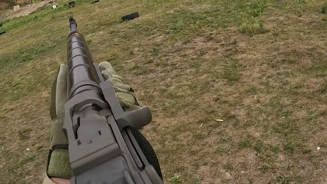 Poltava-Kharkiv region, Ukraine - August 2022: Ukrainian territorial defense fighter shoots from American M14 rifle. M14 rifle in the hands of a Ukrainian soldier.