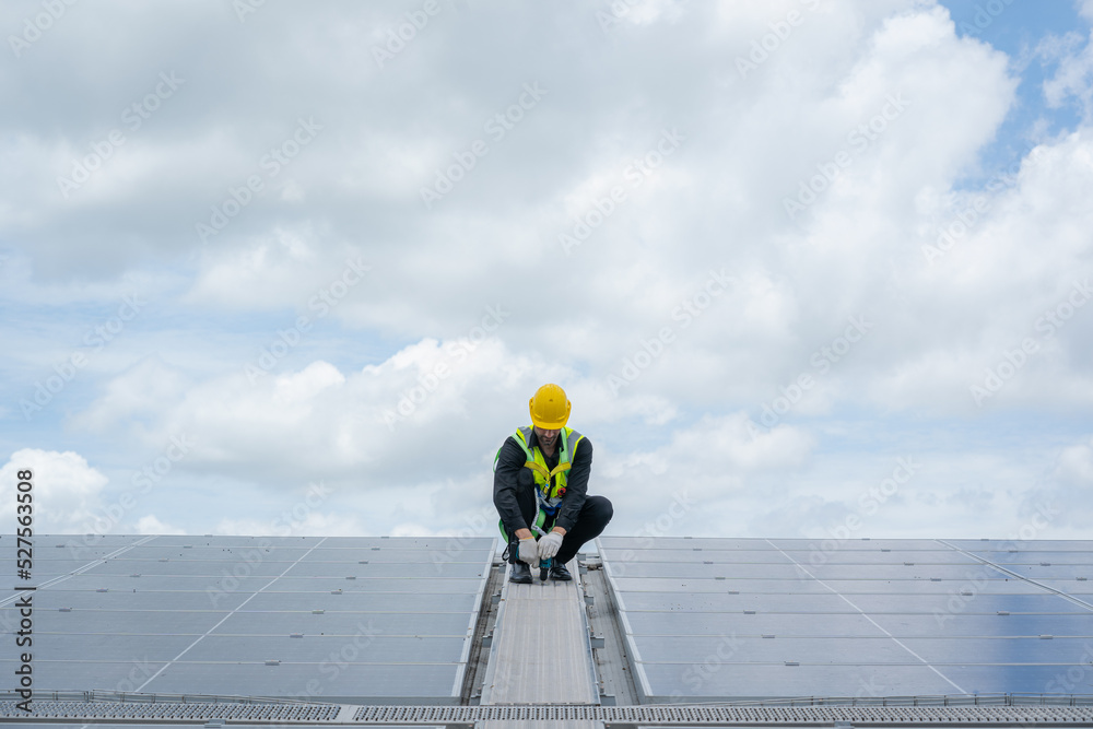 Poster engineers checking solar panel on the roof of factory.