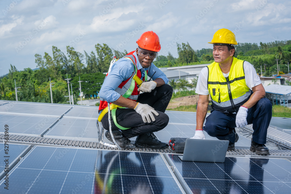 Aufkleber engineers checking the operation of the system solar cell on an building in an residential area,phot