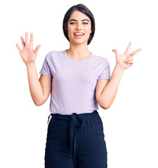 Brunette teenager girl wearing casual clothes showing and pointing up with fingers number eight while smiling confident and happy.