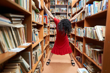 Back to school with attractive librarian in red dress