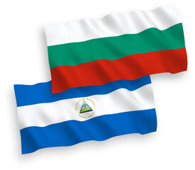 Naklejka premium National vector fabric wave flags of Bulgaria and Nicaragua isolated on white background. 1 to 2 proportion.