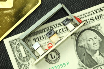Banknote plastic gas station model and gold bar represent economic and money currency concept related idea. 