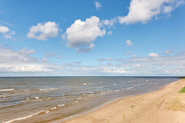 Panoramic view of the Baltic sea from a sandy shore on a sunny summer day. Clouds. Kabli beach, Estonia. Nature, eco tourism, wanderlust, vacation concepts