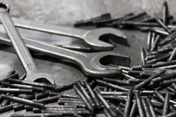 Wrench and screws. Industrial background.