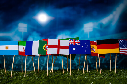 Soccer Wallpaper. Football Ball on green Grass and 32 Flags which will play in Qatar on December 2022