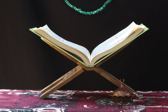 prayer rug, rosary and holy quran and  lectern