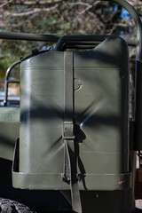 Detail of an old green military SUV. jerrycan