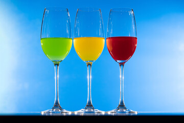 3 color drink in wine glass