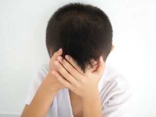 Child headache because stress. suffering migraine. Closeup photo, blurred.