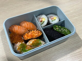 Salmon sushi and roll maki in bento set
