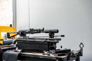 Automatic rifle on stand on the table of the weapons workshop.