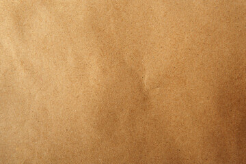 Creased recyclable and reusable wrap natural light brown or beige tone color with blank kraft paper sandy texture background to be use for website page or environmental friendly packaging