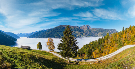 Peaceful misty autumn morning mountain view from hiking path from Dorfgastein to Paarseen lakes,...