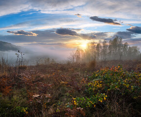 Cloudy and foggy autumn mountain sunrise scene. Peaceful picturesque traveling, seasonal, nature...