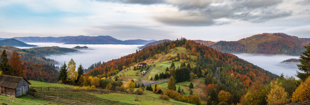Foggy early morning autumn mountains scene. Peaceful picturesque traveling, seasonal, nature and countryside beauty concept scene. Carpathian Mountains, Ukraine.