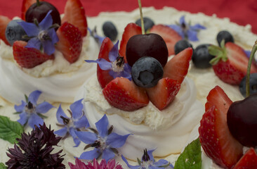 Creamy mascarpone cheese cake with strawberry and edible flowers