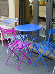 Outdoors colorful cafe bar charis ant table.