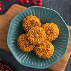 Delicious Cantonese moon cake for Mid-Autumn Festival food mooncake on blue table background.