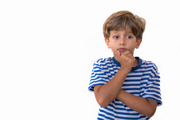 Elementary age boy on a white background with a thoughtful gesture. Image with copy space