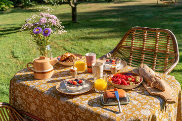 Vintage breakfast on a sunny day with bread, fruit and orange juice 
