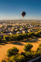 hot air balloon over houses