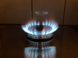 A gas stove burning with blue flame