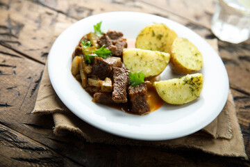 Homemade beef ragout with pickles and potato