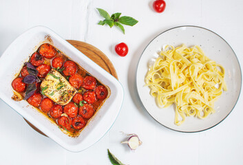 Fetapasta. Trending viral Feta bake pasta recipe made of cherry tomatoes, feta cheese, garlic in a casserole dish.