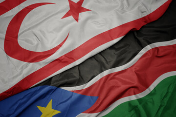 waving colorful flag of south sudan and national flag of northern cyprus.