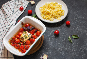 Fetapasta. Trending viral Feta bake pasta recipe made of cherry tomatoes, feta cheese, garlic in a casserole dish.